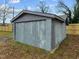 View of the gray siding on the backyard outbuilding in the fenced yard at 670 Mcadams Rd, Hillsborough, NC 27278