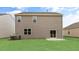 A spacious backyard with a gray siding and sliding glass doors at 107 Ethel Ln, Angier, NC 27501