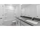 Bathroom showcasing a double sink vanity with modern fixtures and bathtub with white tile surround at 107 Ethel Ln, Angier, NC 27501