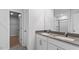 Modern bathroom featuring double vanity with gray countertop and glass-enclosed shower at 107 Ethel Ln, Angier, NC 27501