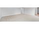 Spacious bedroom featuring neutral carpet, white walls, and a door leading to a walk-in closet at 107 Ethel Ln, Angier, NC 27501