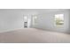 Spacious bedroom showcasing neutral carpeting, and natural light from the large windows at 107 Ethel Ln, Angier, NC 27501