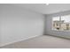 Bedroom with plush neutral carpeting, bright natural light, and views of the neighborhood at 107 Ethel Ln, Angier, NC 27501