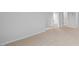 Spacious bedroom showcasing neutral carpeting, and natural light from the nearby doorway at 107 Ethel Ln, Angier, NC 27501