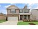 Charming two-story home featuring a brick and siding exterior with a two-car garage at 107 Ethel Ln, Angier, NC 27501