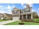 Charming two-story home featuring a brick and siding exterior with a two-car garage at 107 Ethel Ln, Angier, NC 27501