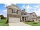 Exterior of a two-story home featuring a brick and siding exterior with a two-car garage at 107 Ethel Ln, Angier, NC 27501