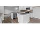 Modern kitchen with stainless steel appliances and gray countertops at 107 Ethel Ln, Angier, NC 27501