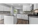 Bright kitchen featuring modern appliances, gray backsplash, and a center island at 107 Ethel Ln, Angier, NC 27501