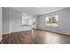 Open-concept living room flowing into kitchen featuring wood floors and natural light at 107 Ethel Ln, Angier, NC 27501