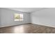 Bright living room with beautiful wood flooring and a large window at 107 Ethel Ln, Angier, NC 27501
