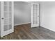 A bright office space with sleek floors, white walls, and French doors providing entry and exit at 107 Ethel Ln, Angier, NC 27501