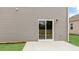 Close-up view of patio with gray siding and sliding glass doors at 107 Ethel Ln, Angier, NC 27501
