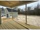 Covered back porch with view of level lot and unfinished garage at 136 Bar Code Ct, Wendell, NC 27591