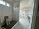 Bathroom featuring elegant white marble tile, shower with built-in bench, and modern vanity at 136 Bar Code Ct, Wendell, NC 27591