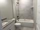 Modern bathroom with gray tile shower, black fixtures, toilet, and granite vanity at 136 Bar Code Ct, Wendell, NC 27591