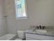 Bright bathroom with neutral tile, granite counters, and a sink next to a tub and toilet at 136 Bar Code Ct, Wendell, NC 27591