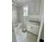 Bathroom featuring a white vanity cabinet, tub, and gray tile wall at 136 Bar Code Ct, Wendell, NC 27591