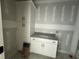 Bathroom features white cabinets, gray granite countertops, and black hardware at 136 Bar Code Ct, Wendell, NC 27591