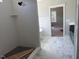 Modern bathroom with a tiled shower and black fixtures, accented by a marble-patterned floor at 136 Bar Code Ct, Wendell, NC 27591