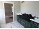 Modern bathroom featuring dual vanities with dark green cabinets and white marble countertops at 136 Bar Code Ct, Wendell, NC 27591