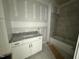 Bathroom features a white vanity with granite countertop and tiled shower/tub at 136 Bar Code Ct, Wendell, NC 27591