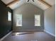 Bedroom with a vaulted ceiling, beam accents, a dark accent wall and large windows, offering plenty of natural light at 136 Bar Code Ct, Wendell, NC 27591