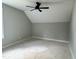 A gray bedroom features a ceiling fan and window at 136 Bar Code Ct, Wendell, NC 27591