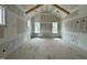 Bright bedroom with vaulted ceiling, large windows, and unfinished drywall ready for personalization at 136 Bar Code Ct, Wendell, NC 27591