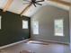 Bedroom with a vaulted ceiling, beam accents, a dark accent wall and large windows, offering plenty of natural light at 136 Bar Code Ct, Wendell, NC 27591