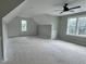 Large bonus room with plenty of natural light, offering a versatile space for recreation or relaxation at 136 Bar Code Ct, Wendell, NC 27591