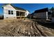 Wide exterior view of new home construction showcasing black roof, covered porch, and brick foundation at 136 Bar Code Ct, Wendell, NC 27591