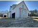 New home with a detached garage showing gray brick and siding under a blue sky at 136 Bar Code Ct, Wendell, NC 27591