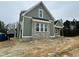 Side view of a new construction home with brick accents and covered porch with wooden posts at 136 Bar Code Ct, Wendell, NC 27591