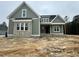 Beautiful new construction with olive siding, grey brick facade, and a covered front porch at 136 Bar Code Ct, Wendell, NC 27591