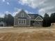 New construction two-story home featuring neutral siding and brickwork with a detached garage at 136 Bar Code Ct, Wendell, NC 27591