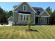Charming exterior view of a well-manicured house with an attached garage and a beautiful, green lawn at 136 Bar Code Ct, Wendell, NC 27591
