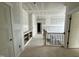 Upstairs hallway with railing, built-in shelving, and natural light, creating a welcoming and functional space at 136 Bar Code Ct, Wendell, NC 27591
