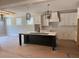 Bright kitchen featuring a central island, modern lighting and white cabinets at 136 Bar Code Ct, Wendell, NC 27591