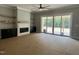 Open living room featuring a fireplace, built-in shelving, and sliding glass doors to deck at 136 Bar Code Ct, Wendell, NC 27591