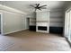 Open living room featuring a fireplace, built-in shelving, and sliding glass doors to deck at 136 Bar Code Ct, Wendell, NC 27591