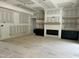 Living room features a fireplace with shelves and dark green cabinets at 136 Bar Code Ct, Wendell, NC 27591