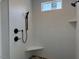 Contemporary shower with black hardware and a built-in shower seat features white tiled walls at 136 Bar Code Ct, Wendell, NC 27591