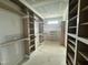 Spacious walk-in closet with custom shelving and natural light, offering ample storage and organization at 136 Bar Code Ct, Wendell, NC 27591
