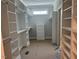 Spacious walk-in closet featuring ample shelving, storage drawers and a window for natural light at 136 Bar Code Ct, Wendell, NC 27591