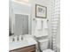 Bathroom with a white vanity, a framed mirror, and a shower/tub combination with a striped curtain at 2308 Beeblossom Pl, Fuquay Varina, NC 27526