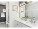 This bathroom features double sinks, a large mirror, modern lighting, and a glass shower at 2308 Beeblossom Pl, Fuquay Varina, NC 27526