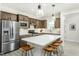 Open kitchen with a large island, stainless steel appliances, and seating, perfect for entertaining guests at 2308 Beeblossom Pl, Fuquay Varina, NC 27526