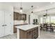 Bright kitchen with a center island, modern appliances, and an open floor plan connecting to the dining area at 2308 Beeblossom Pl, Fuquay Varina, NC 27526
