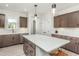 Well-lit kitchen with an island, stainless steel appliances, and cabinetry, creating a functional and stylish space at 2308 Beeblossom Pl, Fuquay Varina, NC 27526